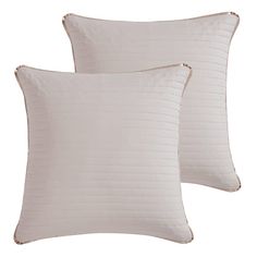 two white pillows sitting next to each other