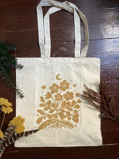 "Soft cotton tote bag - fits a lot! Screenprinted with floral design by Serena. 6.5 oz., 100% cotton canvas 23¼\" self-fabric straps 14.5\"W x 15.5\"H x 7\"D" Cotton Canvas Tote Bag With Screen Print, White Hand Printed Cotton Canvas Bag, Hand Printed White Cotton Canvas Bag, Cotton Hand Printed Bags For Everyday Use, Hand Printed Canvas Tote Bag, Hand Printed Cotton Canvas Tote Bag, Hand Printed Cotton Tote Canvas Bag, Eco-friendly Hand Printed Cotton Canvas Bag, Brown Envelopes