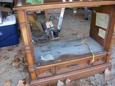 an old wooden desk with many pieces of wood on it and some papers taped to the top