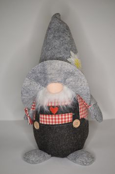 a stuffed gnome with a red and white checkered shirt on it's chest