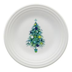 a white bowl with a christmas tree painted on the side in blue and green colors