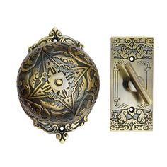 an ornate door handle with a decorative design on the front and back side, next to a switch plate