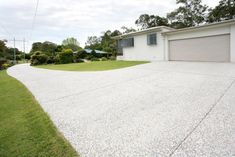 an empty driveway in front of a house