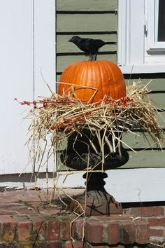 a pumpkin sitting on top of a pile of hay