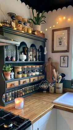 a kitchen filled with lots of pots and pans on top of a wooden counter