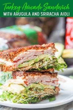 two sandwiches stacked on top of each other with lettuce and meat in the middle