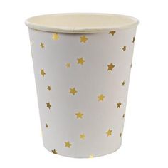 a white cup with gold stars on it