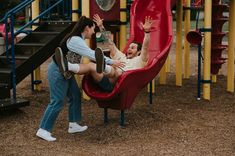 a man and woman playing in a playground