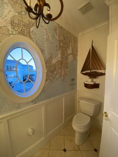 a bathroom with a large round window in it