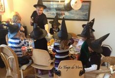 children dressed up as witches sitting around a table