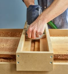 a man sanding wood with a power tool