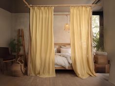 a bed with yellow curtains in a room