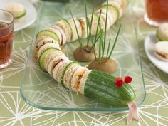 a plate with cucumber and other food items on it