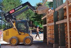 a construction worker is walking past a large bulldozer