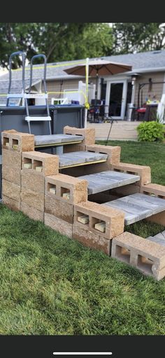 some steps made out of wood sitting in the grass