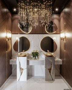 a bathroom with two sinks, mirrors and lights on the wall next to each other