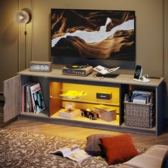 an entertainment center with a large television on it's stand and various items in front of it