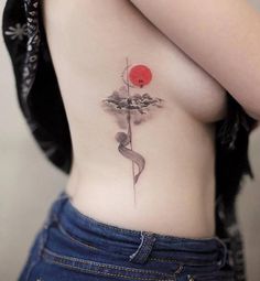 a woman with a tattoo on her stomach holding a red ball in the shape of a snake