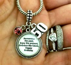 someone is holding their 50th birthday charm