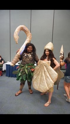 two women dressed in costumes standing next to each other