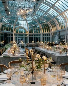 an indoor dining room with chandeliers and tables set for formal dinner or party