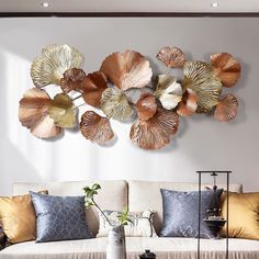 a living room filled with lots of furniture next to a wall mounted metal art piece