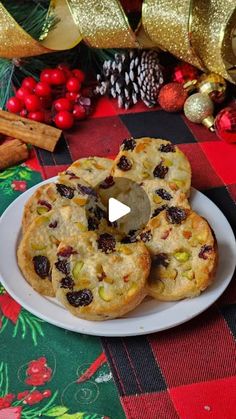 three cookies on a plate with christmas decorations in the background and a red plaid tablecloth