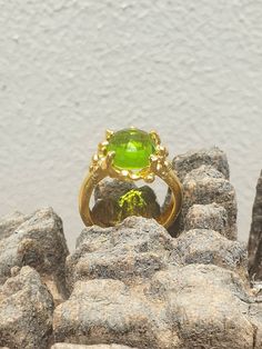 This is gold plated brass peridot ring. A designer handmade ring. It has a design of a coral, holding a green peridot gem. It could be an alternative engagement ring, or a great gift for a loving one. - 14 karat Gold plated brass - Round peridot gem - Free shipping worldwide - Sent in a gift box If you would like to see other rings I have made, please follow this link: https://www.etsy.com/il-en/shop/TamyZurTachshit?ref=seller-platform-mcnav&section_id=17271018 If you would like to go back t Lime Green Gemstone Ring Jewelry, Unique Round Peridot Jewelry, Unique Peridot Jewelry, Lime Green Gemstone Ring, Peridot Ring Jewelry, Lime Green Peridot Ring, Green Fusion Rings For Formal Occasions, Elegant Lime Green Ring For Gift, Elegant Lime Green Rings For Gift