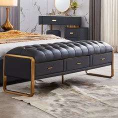 a bed with a black leather bench in front of it and a mirror on the wall