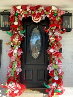 the front door is decorated for christmas with candy canes and bows on it's sides