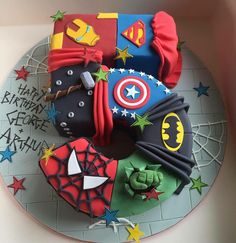 a birthday cake made to look like the avengerss and captain america symbols on top