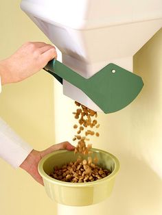 a person is scooping food out of a bowl with a green spatula over it