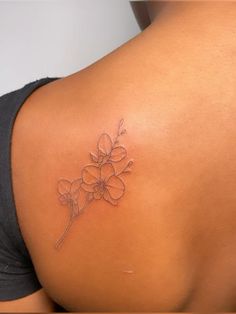 a woman with a flower tattoo on her back