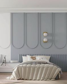 a large bed sitting in a bedroom next to a wall mounted light above it's headboard