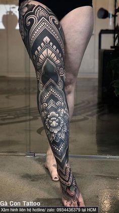 a woman with tattoos on her legs and leg