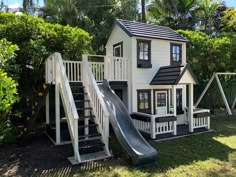 a small house with a slide in the yard