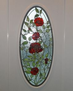 a stained glass window with red roses on it