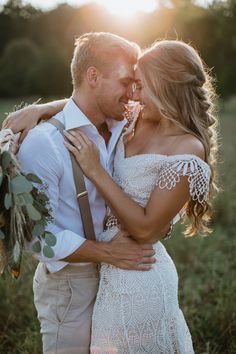 a bride and groom laughing together in the snow