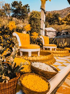 sunflowers and other flowers are on display in front of chairs with yellow cushions