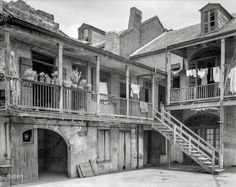 an old building with two balconies on the second floor and three story balconys