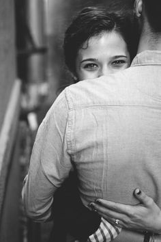 black and white photograph of a man hugging a woman's back in an elevator