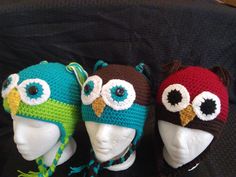 three crocheted hats on top of each other with eyes and ears in different colors