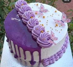 a purple and white cake with butterflies on it