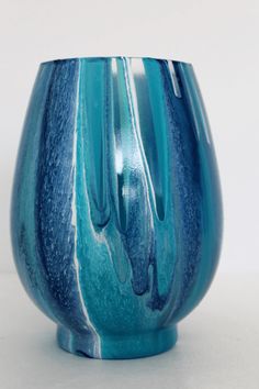 a blue vase sitting on top of a white table