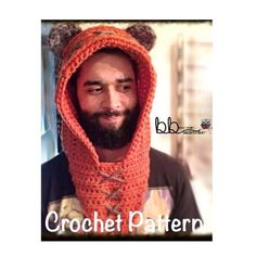 a man with a beard wearing an orange knitted hood and bear ears on his head