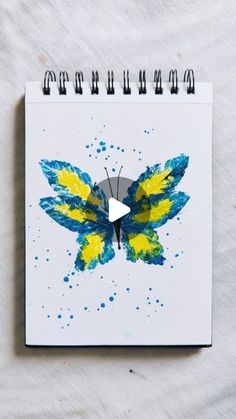 a drawing of a butterfly with yellow and blue paint on it's wings is shown