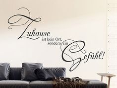 a living room with a couch and wall decals on the walls that say, laubasse ist kein or sonderen en gefiil