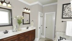 a bathroom with two sinks, mirrors and a bathtub in the middle of it