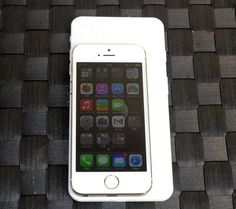 an iphone sitting on top of a wooden table