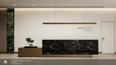 an office lobby with marble counter tops and plants on the wall above it, along with white walls